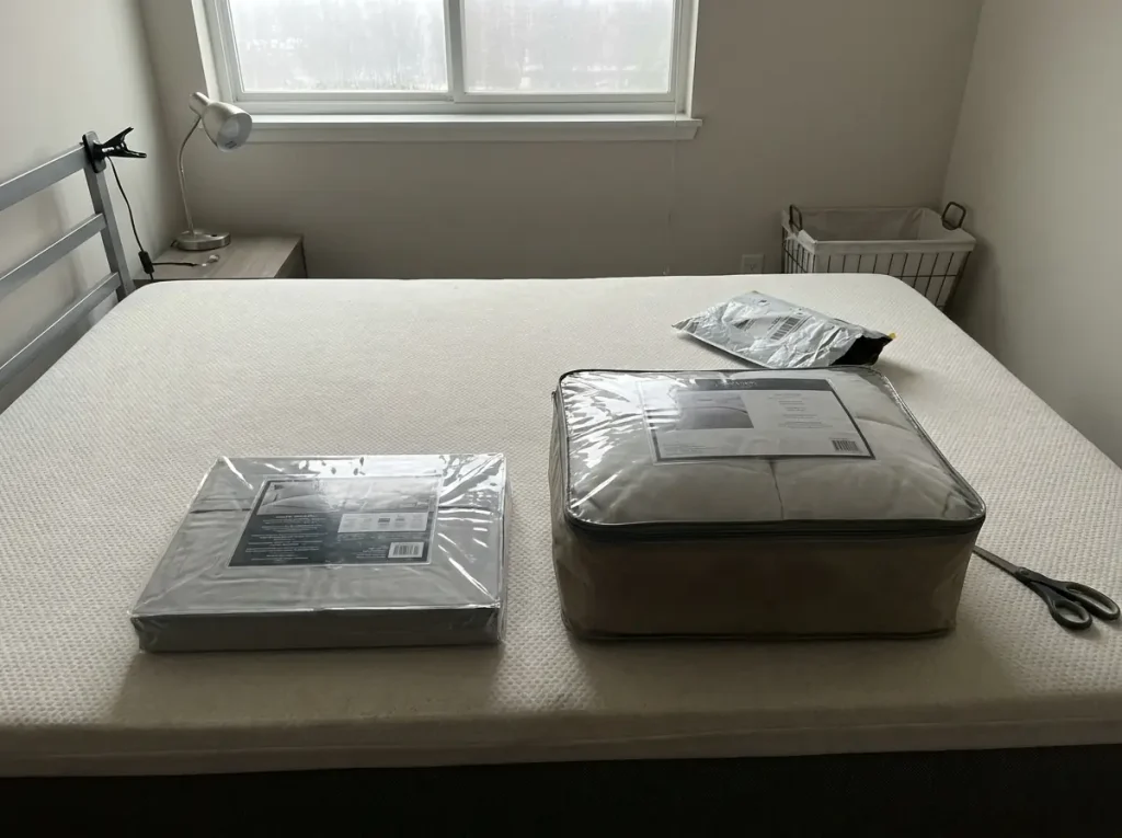A sheet set package and a comforter package laid side by side, both turned to their spec panels