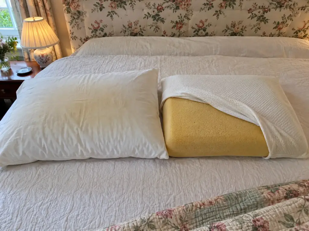 A pale cotton pillow shell beside an amber foam pillow core, showing two different kinds of yellowing