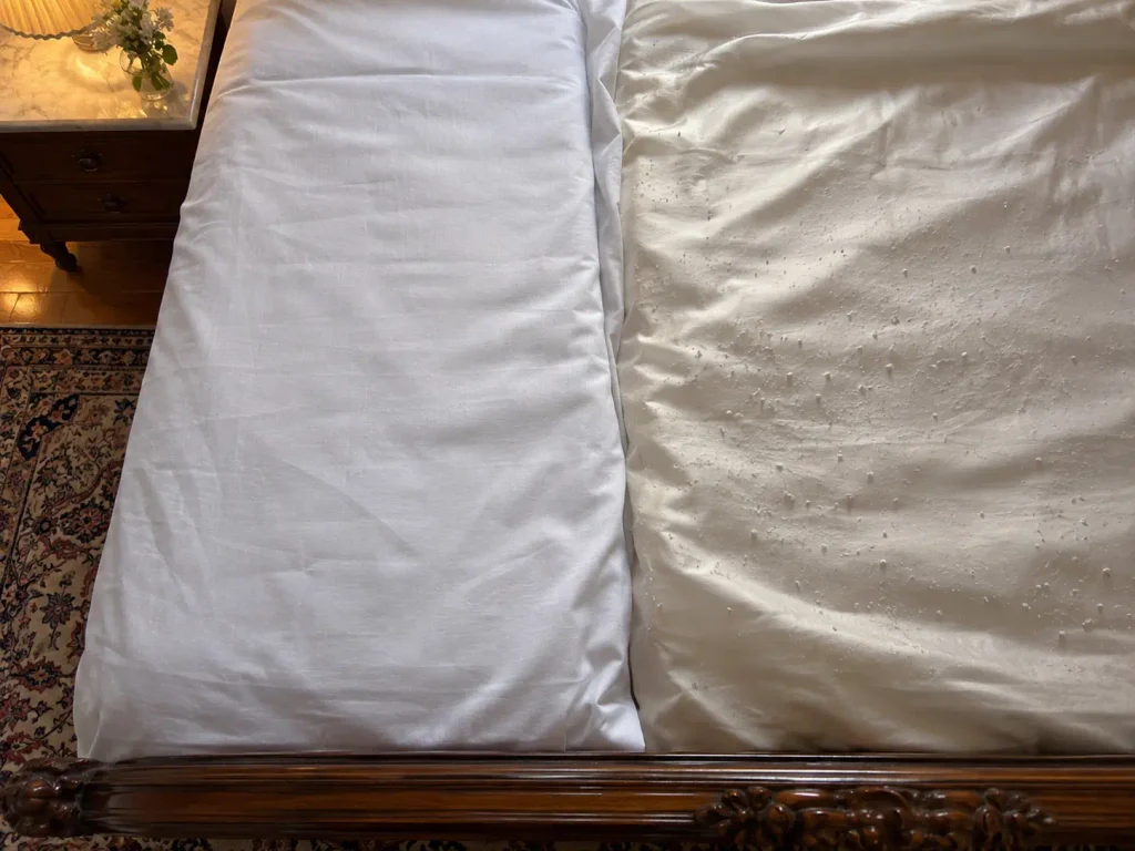 Two cotton sheets laid side by side, one matte and smooth, the other showing a fine scatter of pills