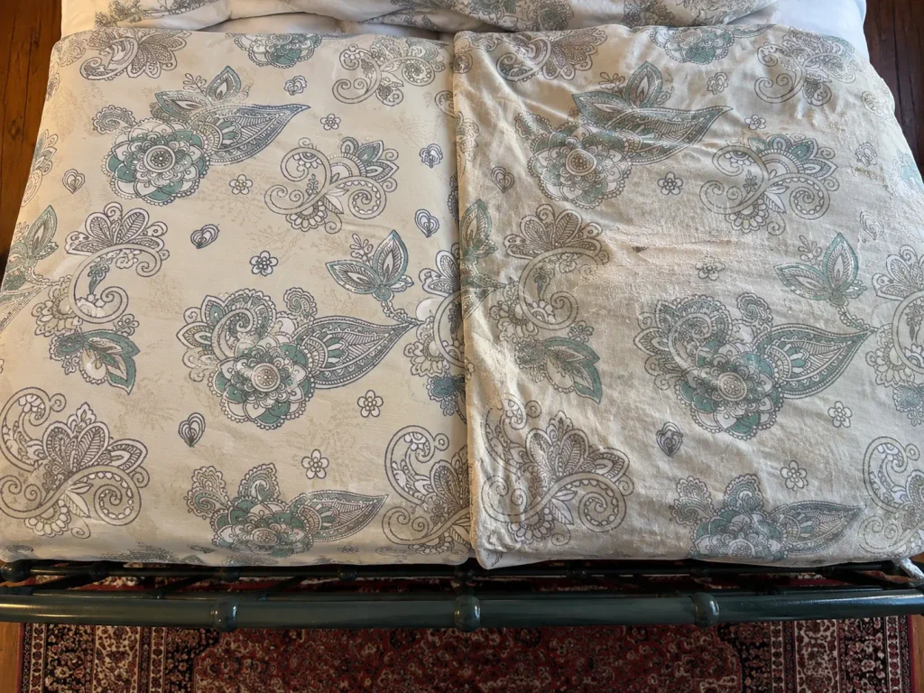 Crisp matte percale beside a worn low-sheen sateen, the weaves compared in raking light