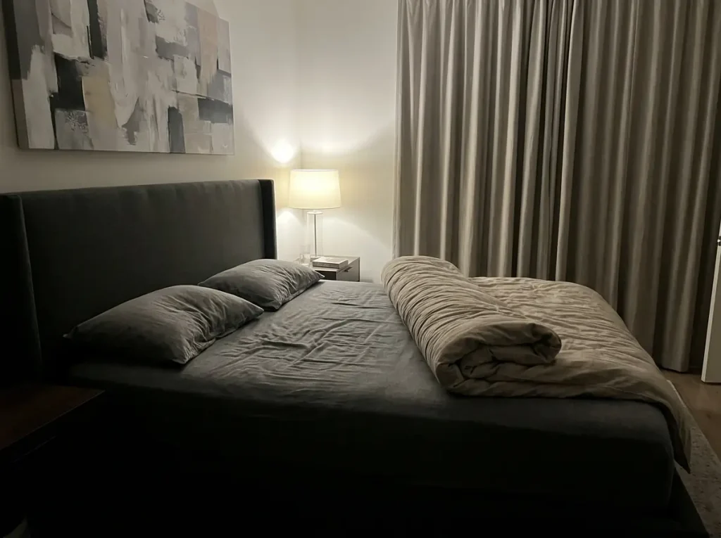 Flannel bedding pushed right off one side of the bed at three in the morning
