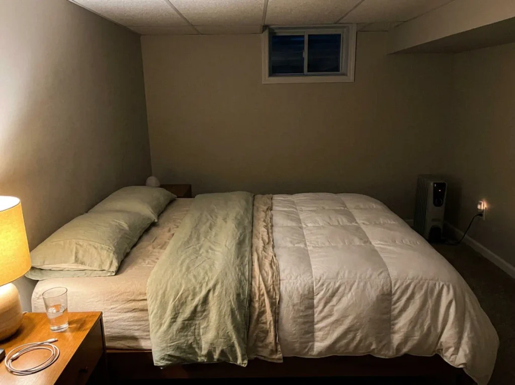 Two separate duvets made up side by side on one bed, a seam of sheet showing between them
