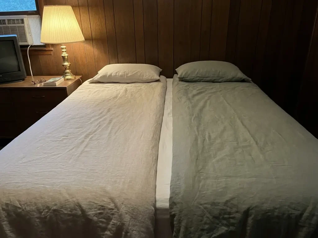Two separate duvets made up side by side on one bed, meeting in a seam down the middle